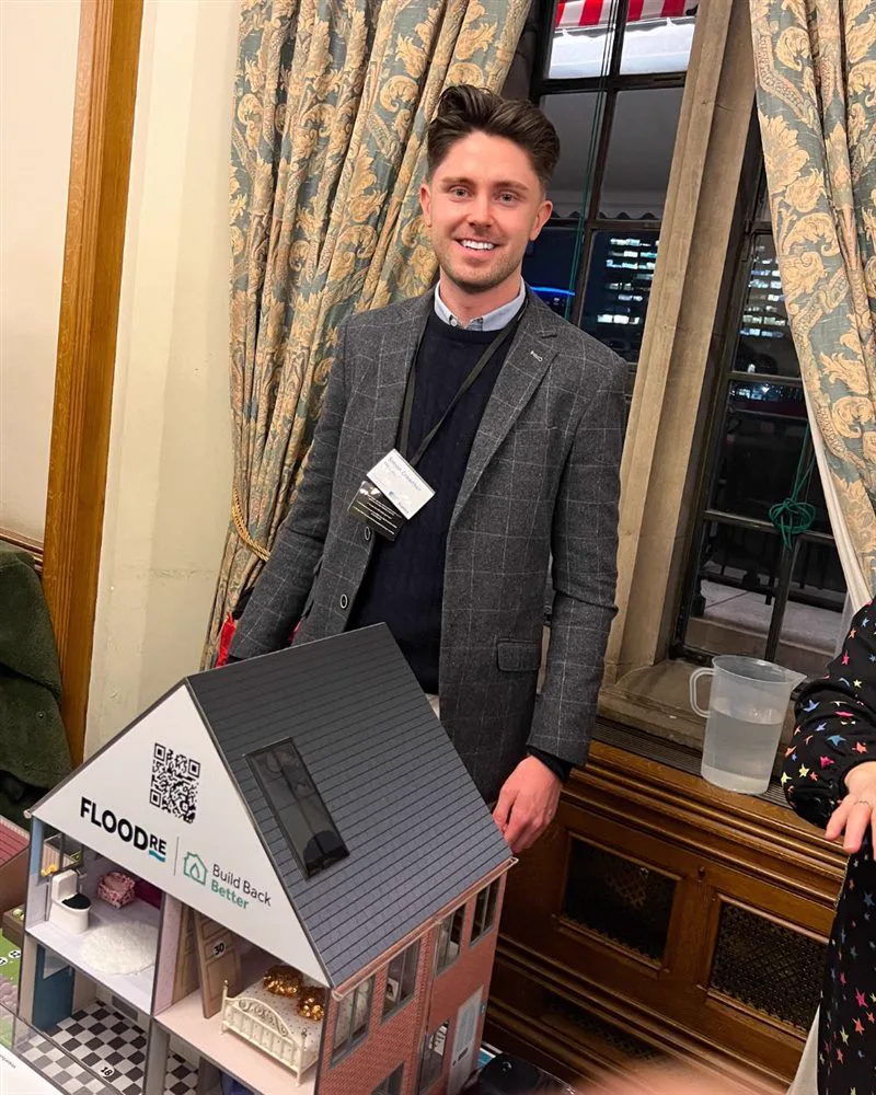 Simon Crowther with a flood model at the House of Commons for Flood Re