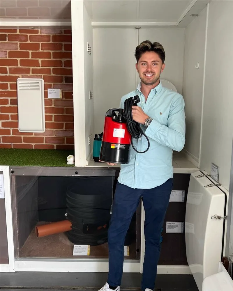 Simon Crowther on the Floodmobile holding a puddle pump