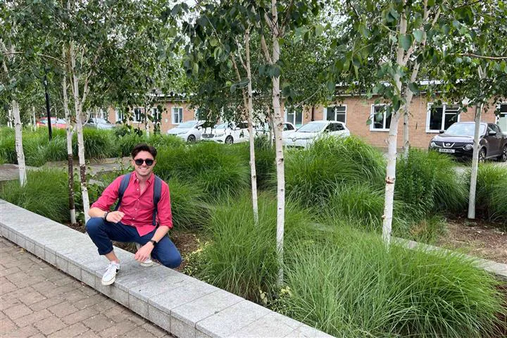 Simon Crowther beside a sustainable drainage and planting scheme