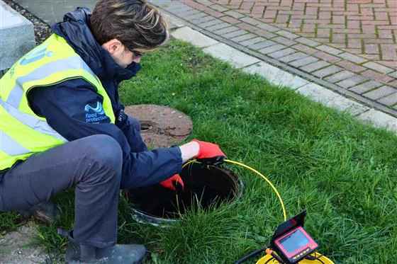 Running a drain survey camera into an inspection chamber